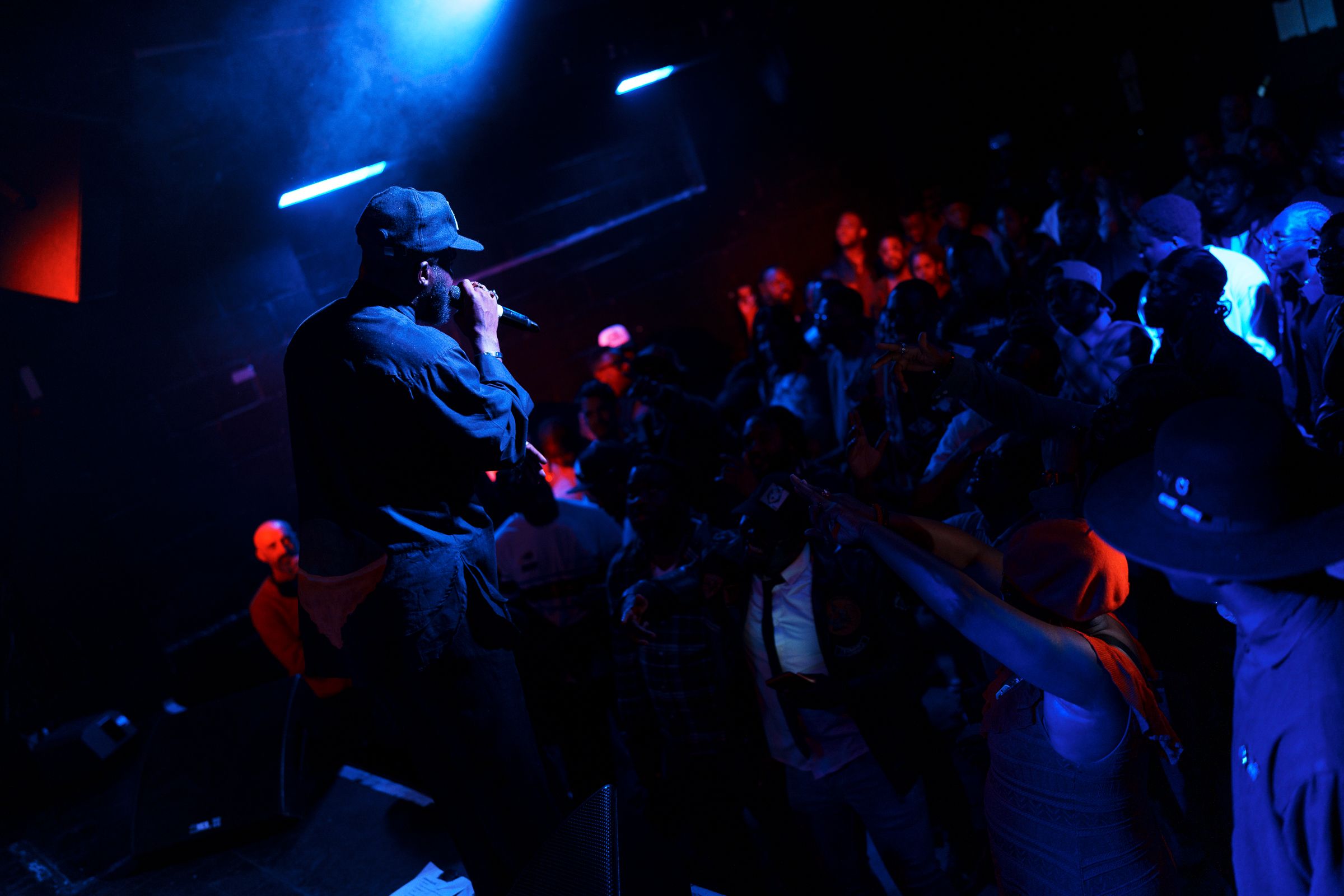 Performer on stage bathed in dramatic light